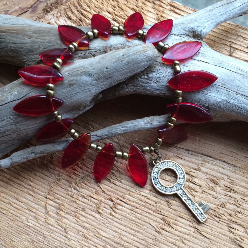 Handmade glass bead bracelet with key charm